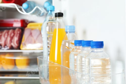 Preview: Bottles of beverages on refrigerator door shelf, closeup