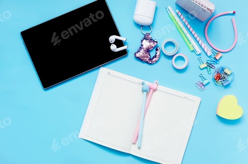 Preview: Online education concept. School supplies on blue background.