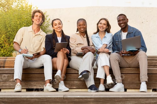 Preview: Portrait of happy multiethnic students posing at university campus
