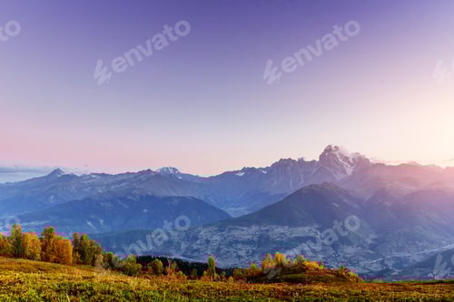 Preview: Magic autumn landscape and snow-capped mountain peaks. View of t
