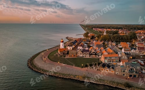 Preview: Urk Flevoland Netherlands sunset at the lighthouse and harbor of Urk Holland. Fishing village Urk