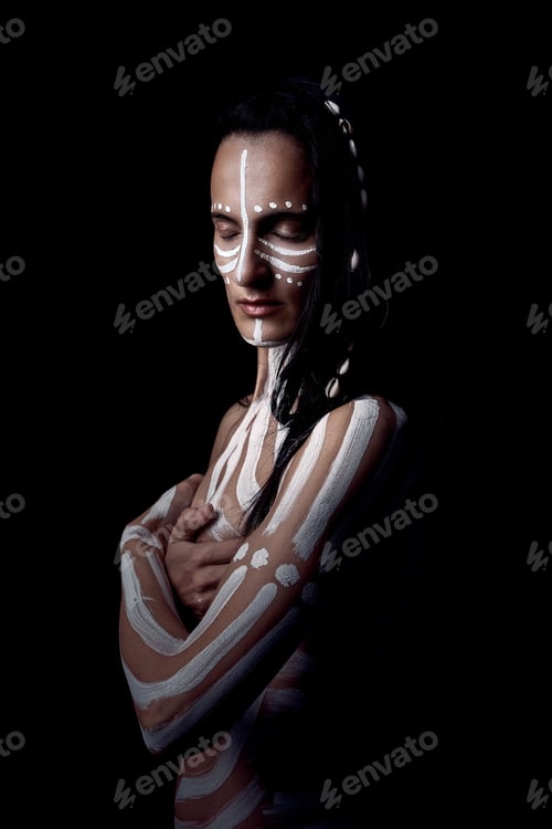 Preview: Young woman standing with body art in dark room