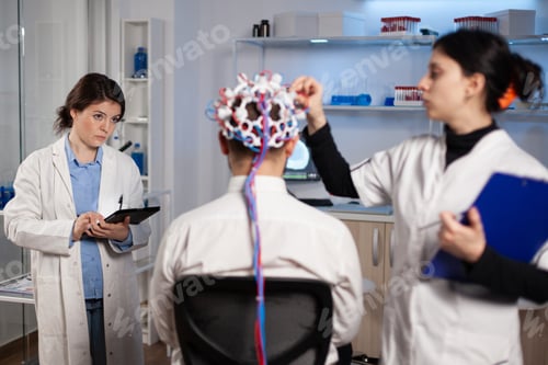 Preview: Man patient with eeg headset for activity scan standing in neurological laboratory