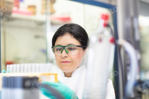 Preview: Focused scientist examining a sample in a laboratory.