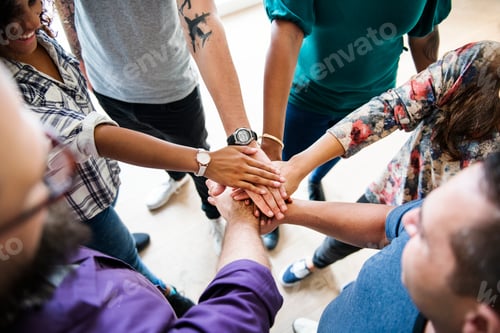 Preview: Group of diverse people joined hands together teamwork