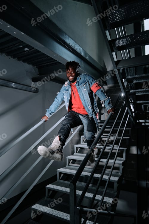 Preview: Young man jumping downstairs in building