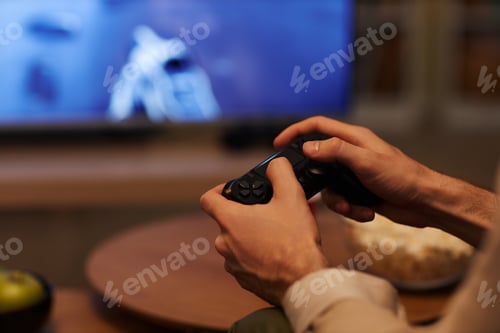 Preview: Unrecognizable ,an holding controller playing videogames at home