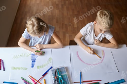 Preview: Two children drawing at the table, top view
