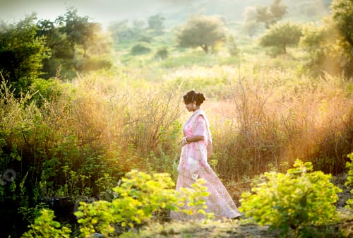 Preview: Portrait of beautiful bride outside in nature at sunset.