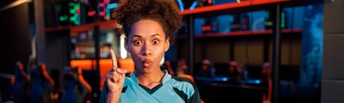 Preview: Funny woman gamer standing in room of gaming club