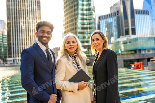 Preview: Diverse business team smiling posing outdoors in city