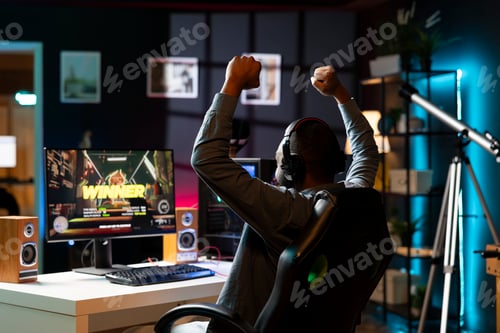 Preview: Gamer playing with friends online celebrating winning