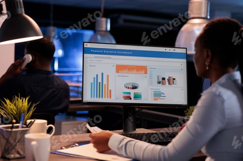 Preview: Female freelancer working with statistics charts on computer monitor