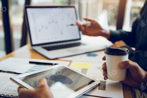Preview: Business partnership pointing to the graph of the company financial statements report