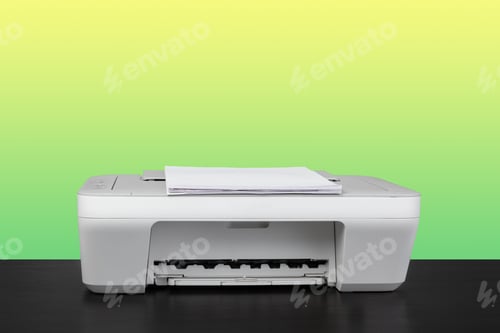 Preview: Home laser printer on desk against green background