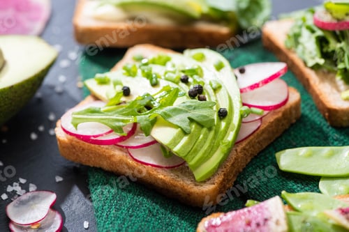 Preview: fresh vegetarian sandwiches with radish, avocado and green peas on cloth