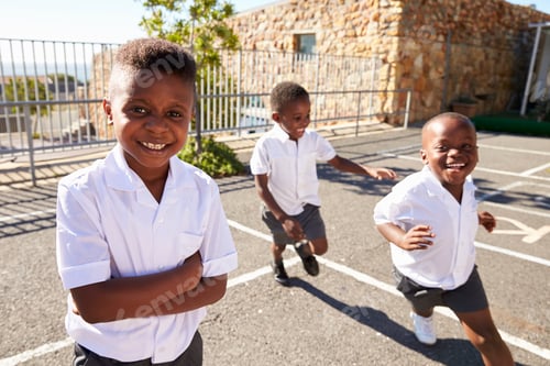 Preview: Young African schoolboys running in school playground