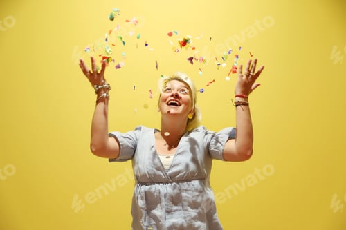 Preview: Woman Celebrates Throwing Colorful Confetti in Studio