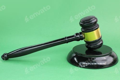 Preview: judge's gavel with a green background.