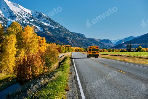 Preview: School bus on highway in Colorado at autumn