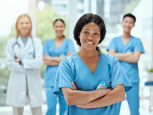Preview: Ready and bright-eyed. Shot of a group of medical practitioners standing together in a hospital.