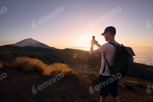 Preview: Man Captures Mountain Sunset on Mobile Phone