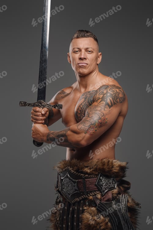 Preview: Handsome warrior with muscular build and sword looking at camera