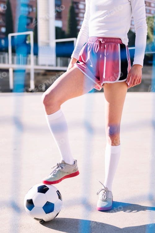 Preview: legs of a football player stepping a soccer ball