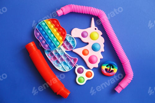 Preview: colorful antistress sensory fidget toys on a blue background