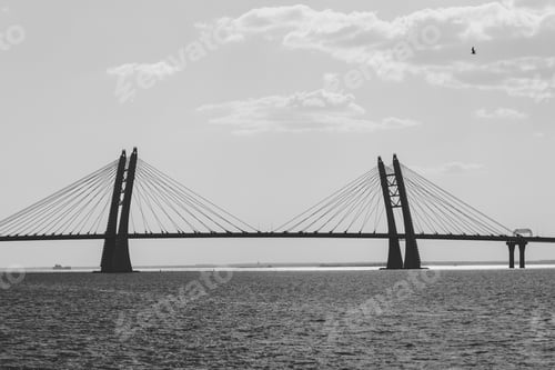 Preview: Black and white photography of modern car bridge over water.