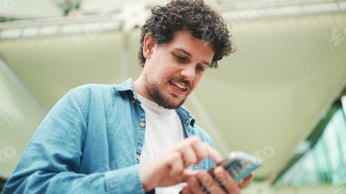 Close-up, man looks at google map on mobile phone and looks around on modern city background