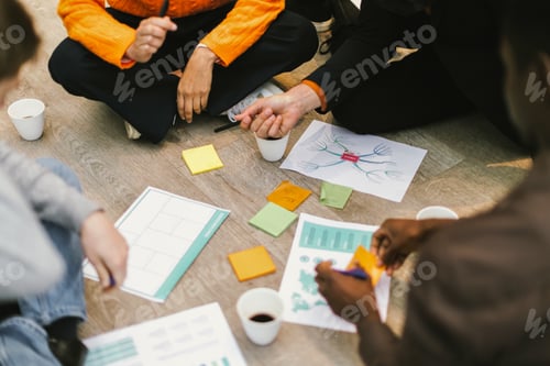 Preview: Business people planning strategy using sticky notes during meeting