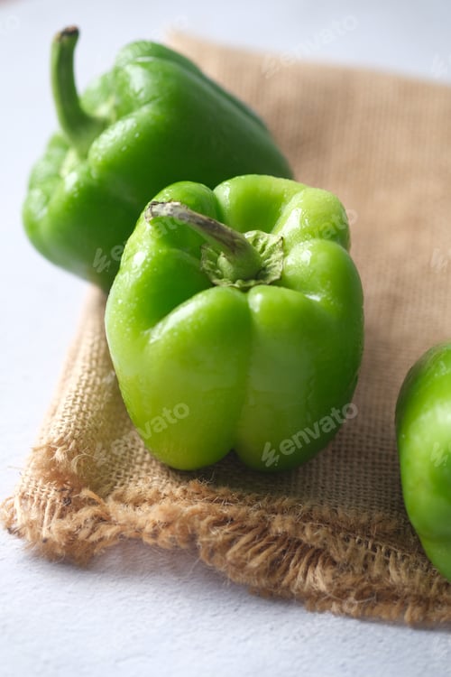 Preview: green color capsicum on wooden background