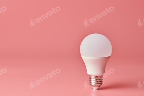 Preview: Energy saving light bulb, copy space, pink background. Minimal idea concept.