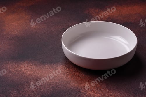 Preview: Empty ceramic round plate on dark textured concrete background