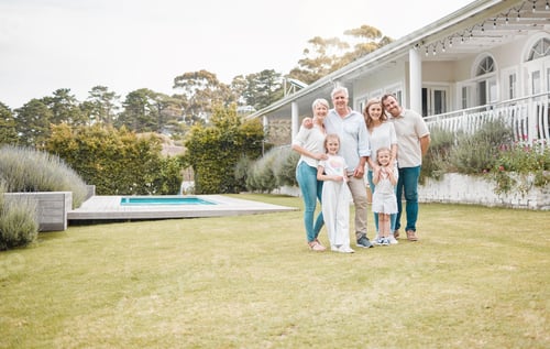 Preview: Happy cheerful family standing together outside in the garden. Family relaxing outdoors with their