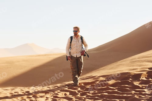 Preview: With photographic equipment. Male tourist in casual clothes is in the deserts of Africa, Namibia