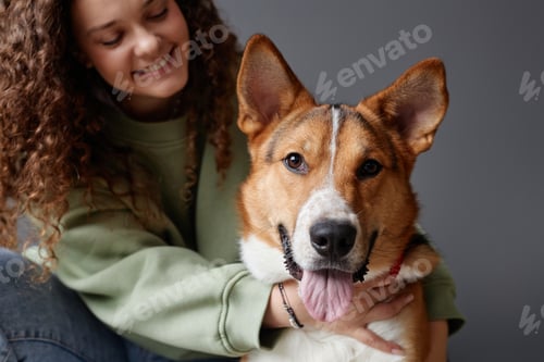 Preview: Happy Dog Looking at Camera with Girl Embracing