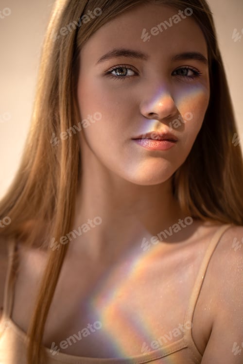 Preview: Young woman with long hair and soft features, illuminated by natural light