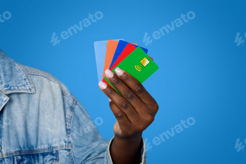 Preview: Cropped of black woman holding various colorful bank cards