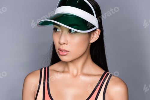 Preview: Portrait shot of beautiful asian woman in visor looking aside