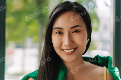 Preview: Beautiful young asian woman smiling with perfect teeth, looking at camera, dental care