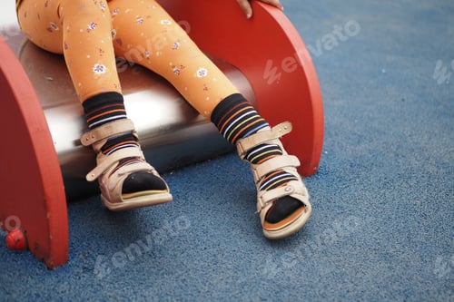 Preview: Child cerebral palsy disability with legs orthosis shoe