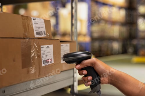 Preview: Close up of black woman worker scanning packages in a large storehouse