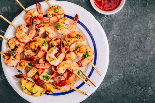 Preview: Sweet Chili Shrimp Skewers with lemon and parsley on gray stone background