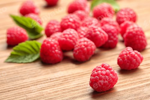 Preview: Ripe aromatic raspberries on wooden table