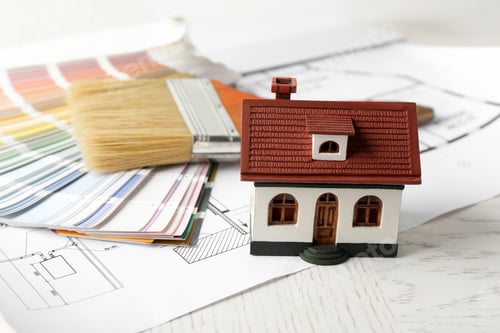 Preview: Composition with house model, color palette and brush on table