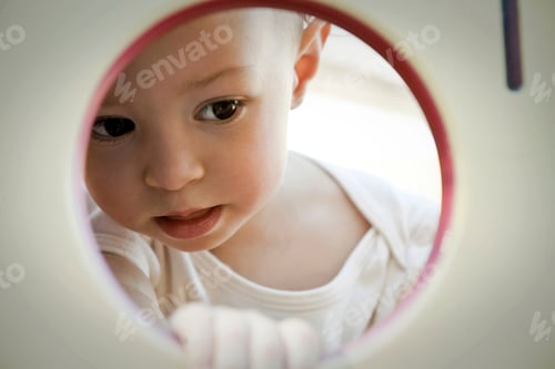 Preview: Little girl looking through circle