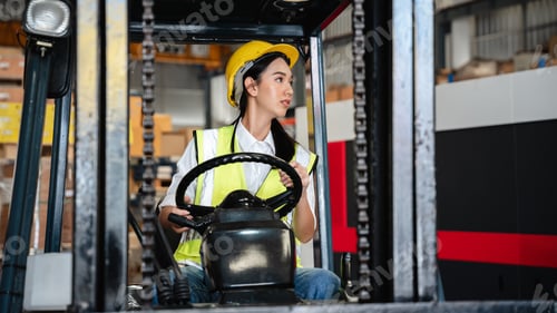 Preview: A warehouse worker forklift operator moves packages around with a manufacturing facility.