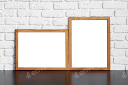 Preview: Blank picture frame against brick wall with copy space